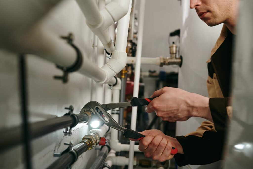 Plumbers maintaining commercial plumbing pipes in Silver Spring