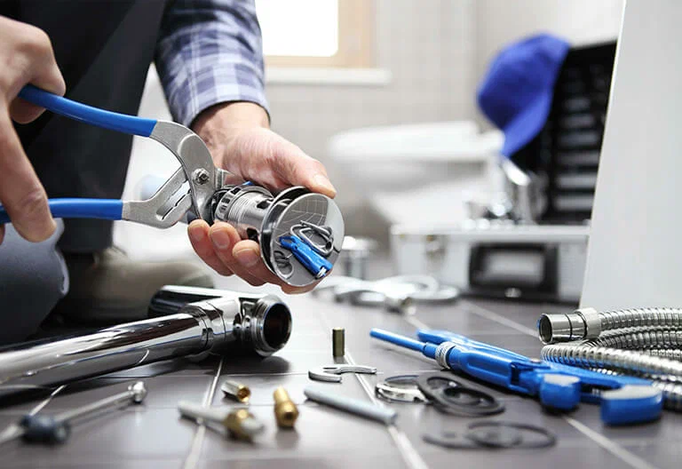 Technician repairing a plumbing fixture with professional tools in Silver Spring