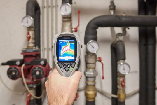 Plumber using a thermal imaging camera to inspect pipes in Silver Spring