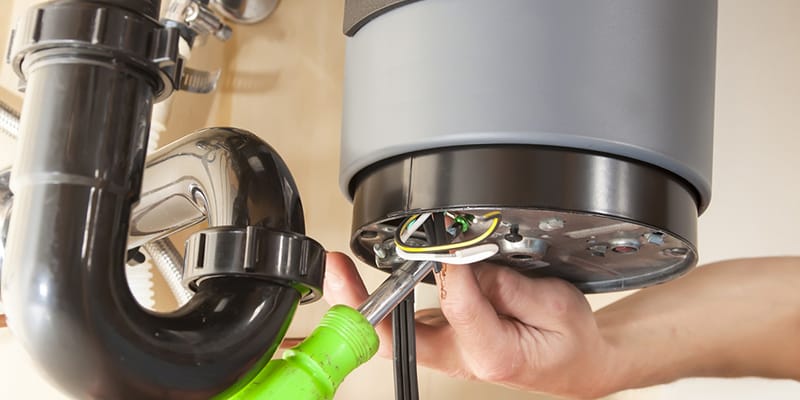 Technician repairing the heating element of a water heater in Silver Spring