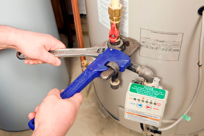 Plumber repairing a water heater valve in Silver Spring
